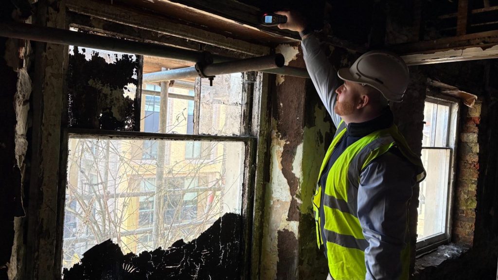Timberwise surveyor inspecting moisture in building.