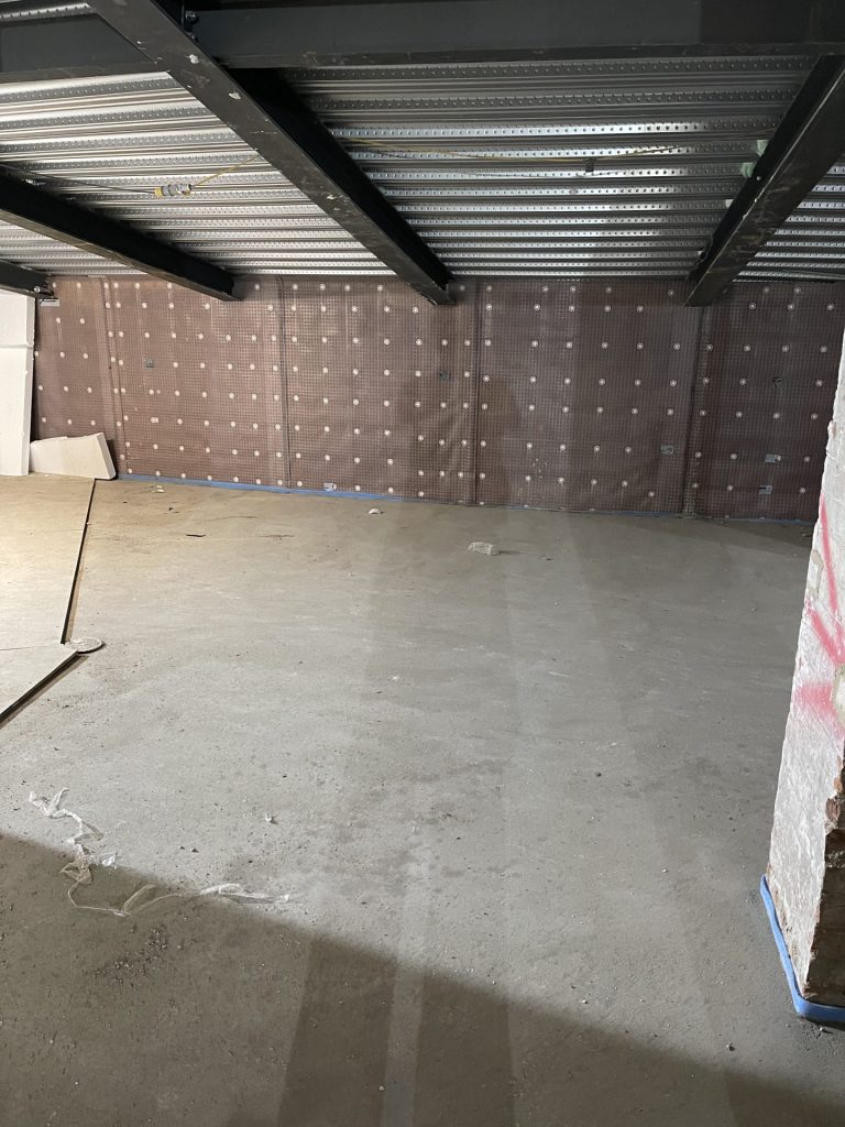 Basement wall with membrane waterproofing.
