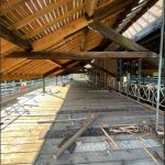 A view of the underside of the canopy showing the newly installed rafter timbers alongside existing timbers. Work at this point has been completed. Some scaffolding still remains under the canopy.