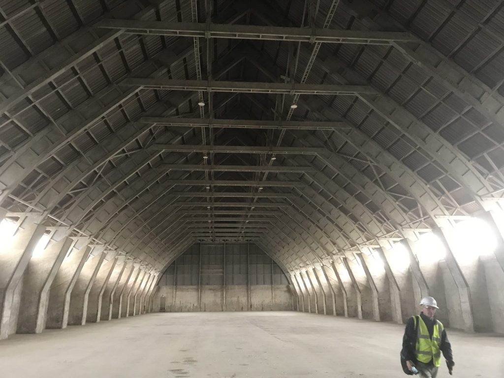 A photo of the Grain Storage, with an emphasis on the scale of the roof in relation to the rest of the space.