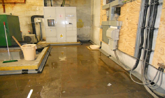 London Clay and Flooding: Structural Repair Risks Explained 2 A basement with large pools of water from water ingress