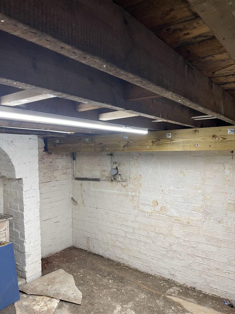 Empty basement in Lincoln with an installed carrier beam