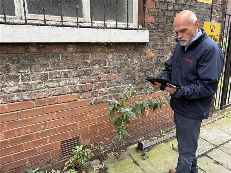The Seven Signs of Rising Damp in London Homes 20 Timberwise surveyor carrying out a damp check