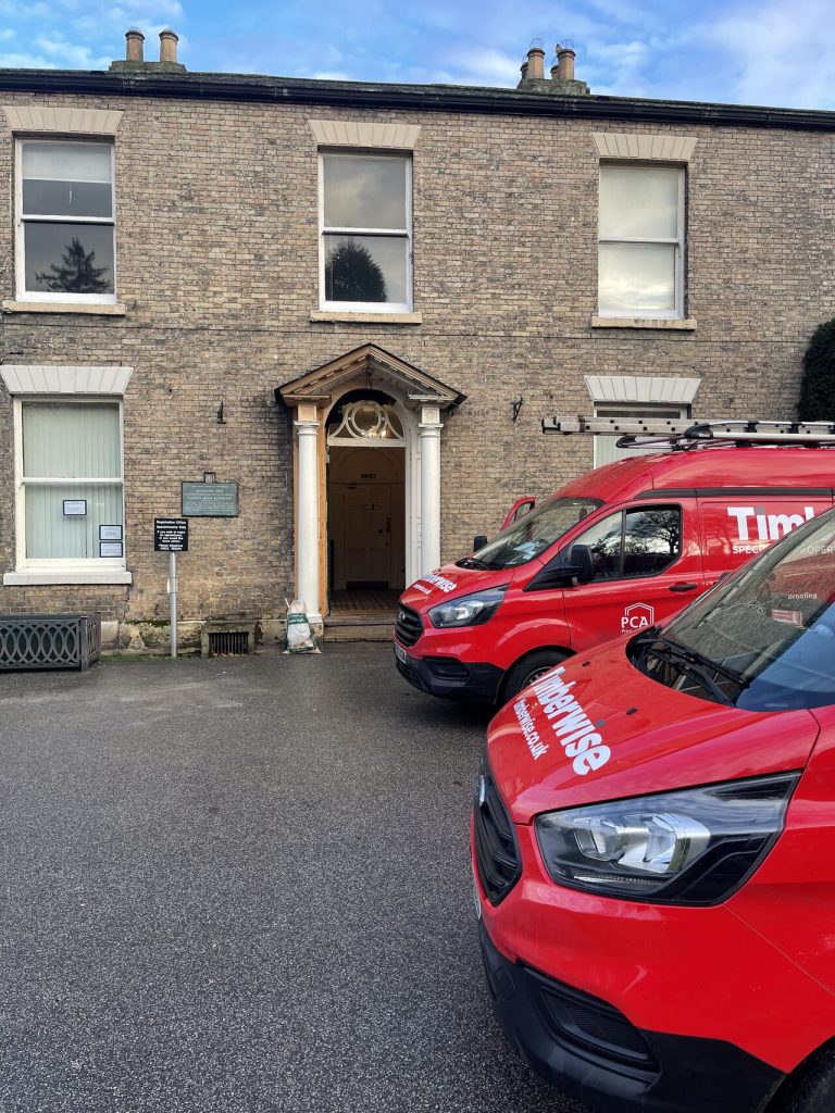 Timberwise vans outside an address in Lincoln for a damp survey