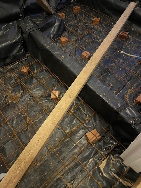 Why are Structural Defects Common in London Homes? 4 reinforcement bars being laid prior to concrete being poured