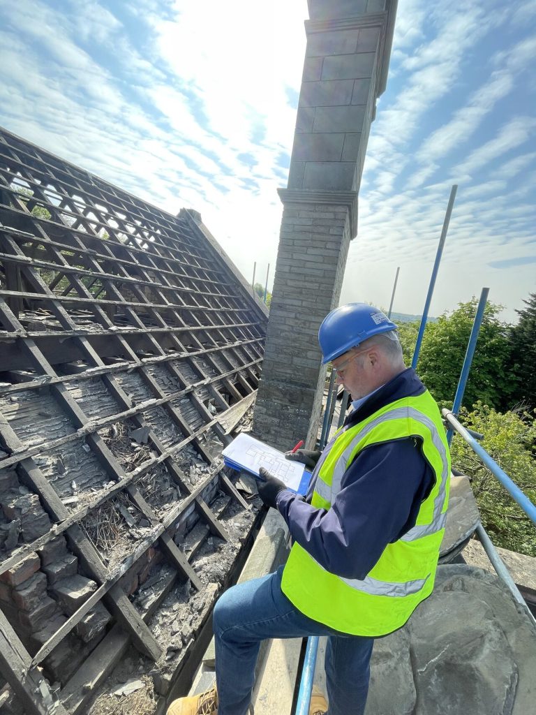 Why are Structural Defects Common in London Homes? 1 Timberwise surveyor inspecting timber roof structure in Wakefield.