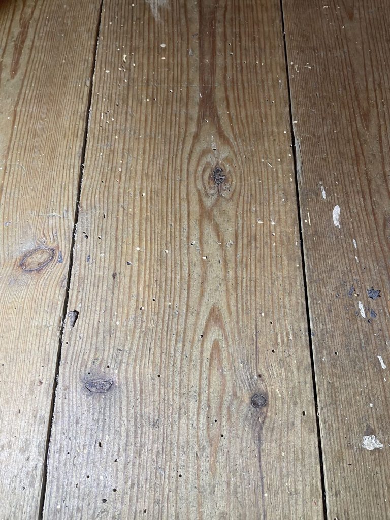 Wooden floorboards with visible damage in a property in Newcastle.
