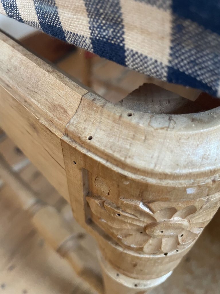 Woodworm damage on dining chair frame in a London property