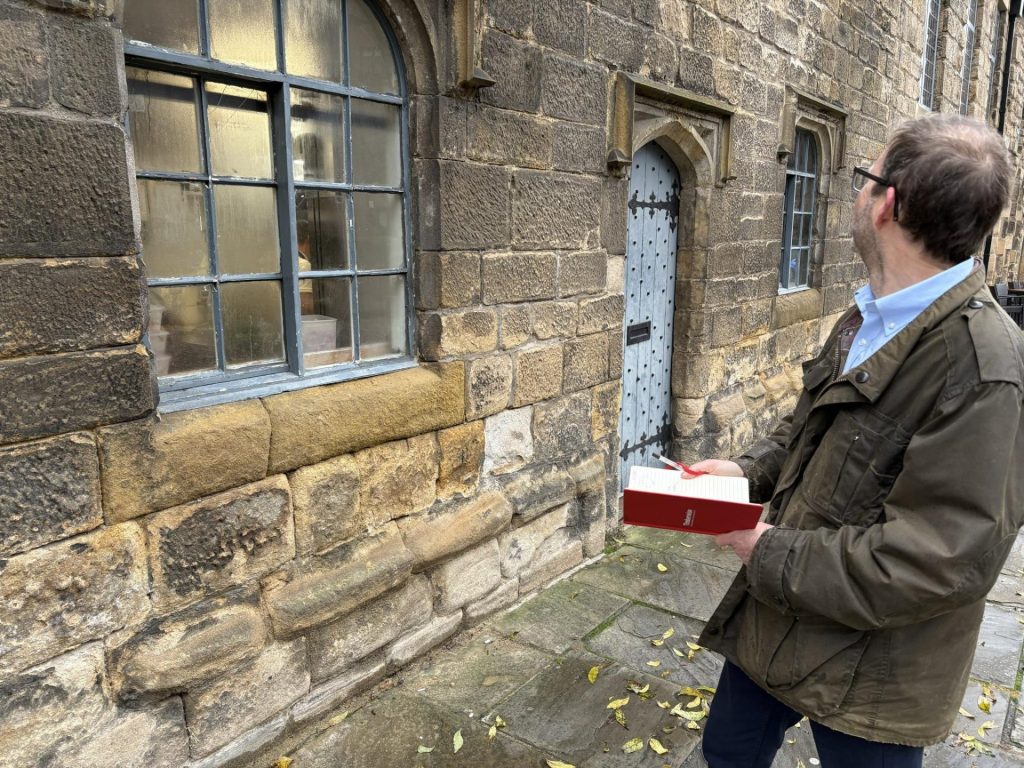 Why Timber Windows Rot and How to Prevent It 3 A Timberwise surveyor assessing a stone property with timber windows