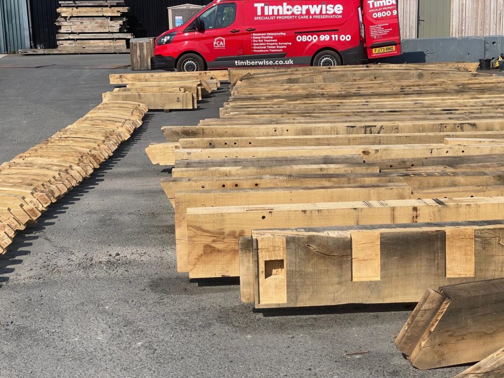 A Timberwise van parked behind rows of treated timbers