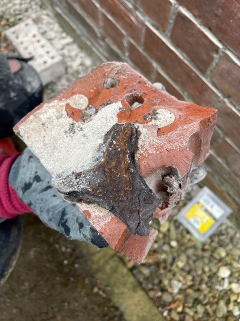Wall Tie Failure and Structural Damage: What You Need to Know 2 A damaged brick with wall tie corrosion