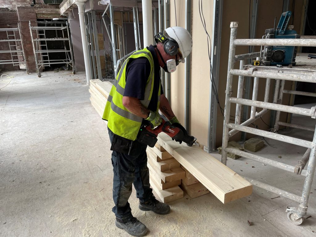 How Timberwise Protects Office Staff, Surveyors and Site Technicians Every Day 1 A technician cutting a piece of timber