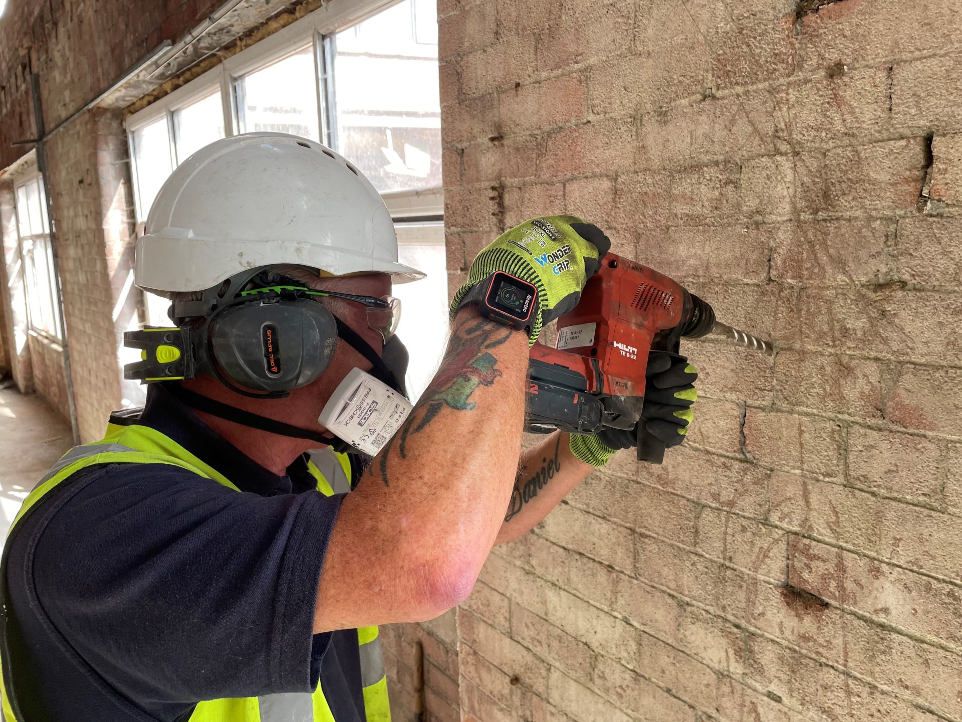 Timberwise Blog 24 A technician drilling into a masonry wall