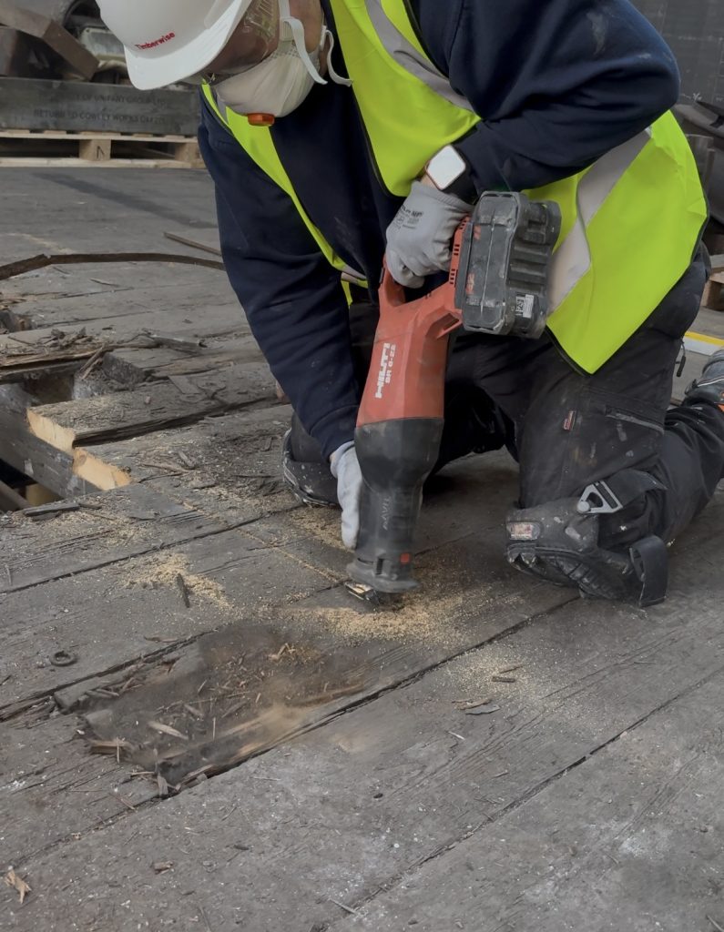 How Do We Choose and Maintain the Tools We Use? 4 A technician using a saw on floorboards